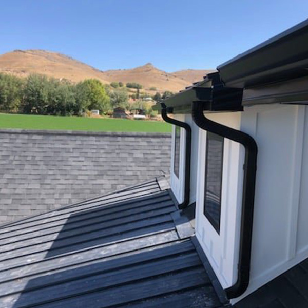 Modern K-style rain gutters and downspouts installed on a home exterior in Salt Lake County, UT