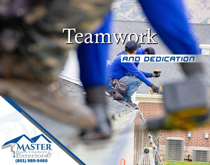 Team of workers on a rooftop demonstrating teamwork and dedication in Salt Lake County, UT